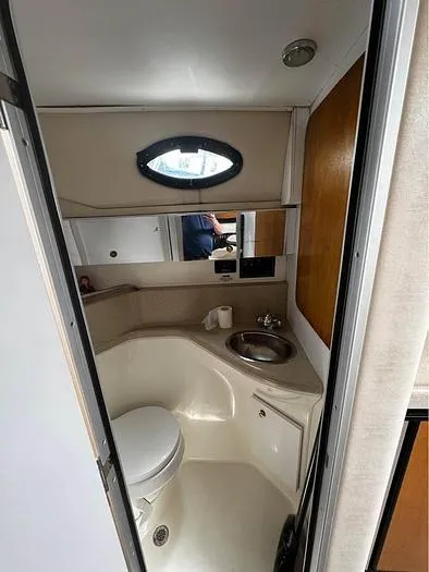Slide: The Image of Wellcraft 3200 boat bathroom interior with sink, toilet, and mirror, 2000 model. - 18