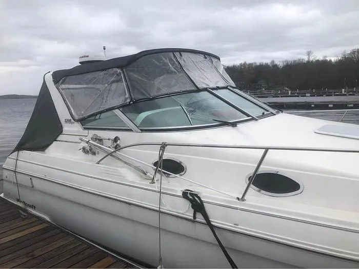 Slide: The Image of Wellcraft 3200 boat, 2000 model, docked on a cloudy day. - 5