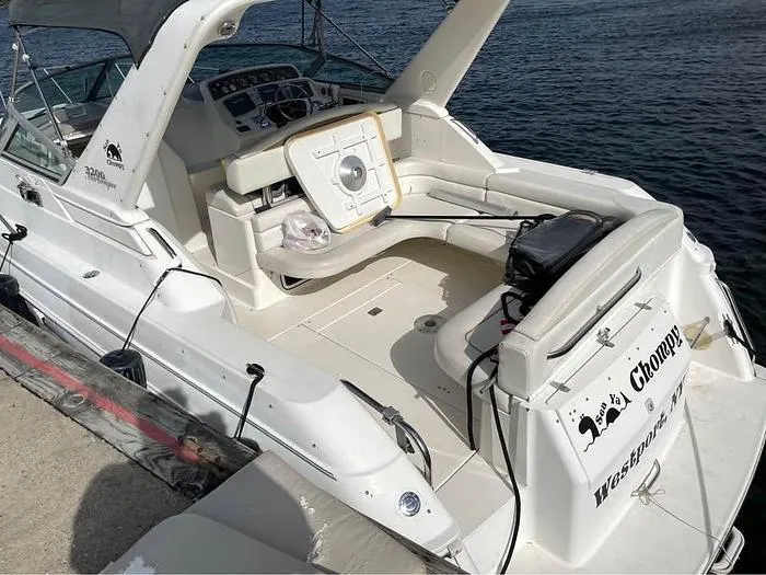 Slide: The Image of Wellcraft 3200 boat, 2000 model, docked with spacious seating and control panel. - 7