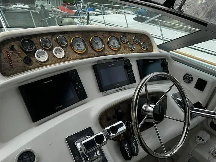 Slide: The Image of Control panel of a 2000 Wellcraft 3200 boat with gauges and navigation screens. - 8