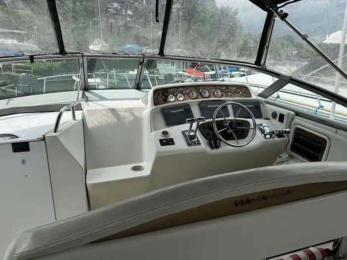 Slide: The Image of Cockpit of 2000 Wellcraft 3200 boat with steering wheel and control panel. - 9