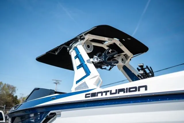 Slide: The Image of 2022 Centurion Ri265 boat with sleek design and advanced features under clear blue sky. - 1