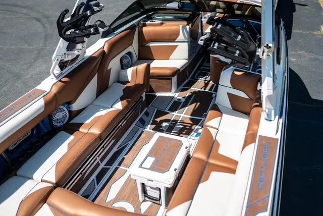 Slide: The Image of Luxurious 2022 Centurion Ri265 boat interior with brown and white seating and advanced audio system. - 11