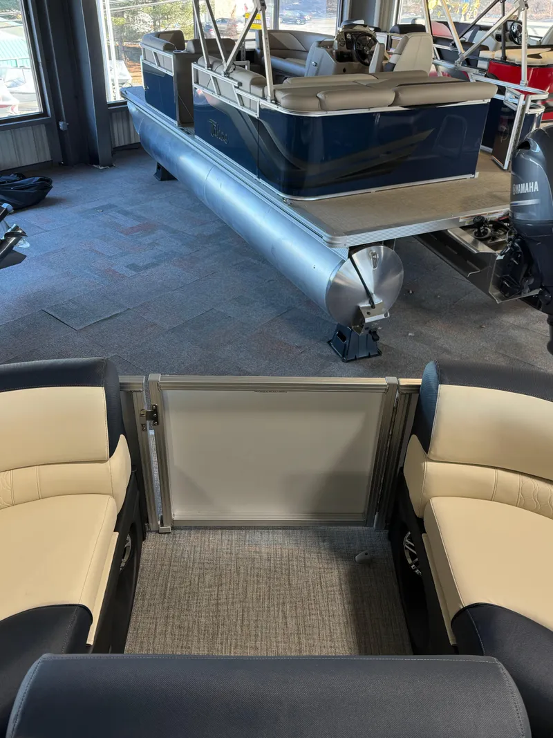 Slide: The Image of 2025 Tahoe Pontoon LTZ Versatile Rear Bench in showroom, featuring plush seating and sleek design. - 11