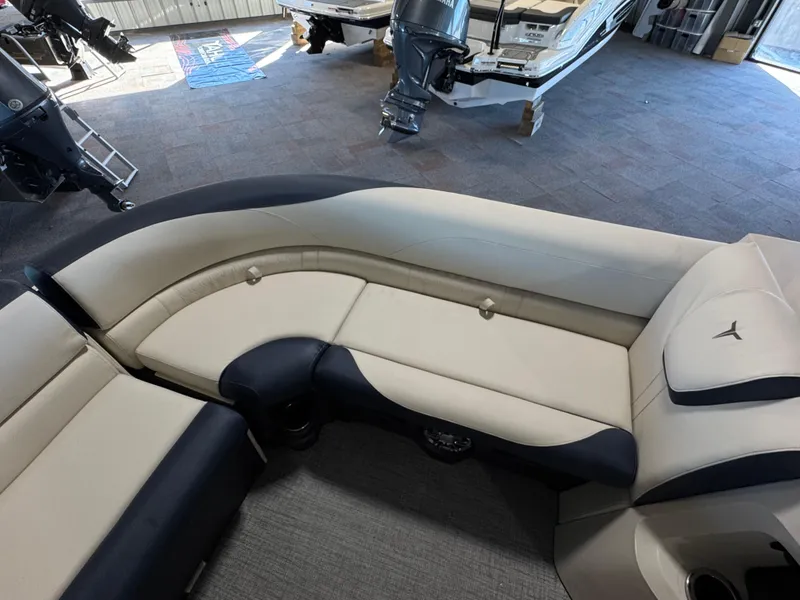 Slide: The Image of 2025 Tahoe Pontoon LTZ Versatile Rear Bench with beige and black seating in showroom. - 13
