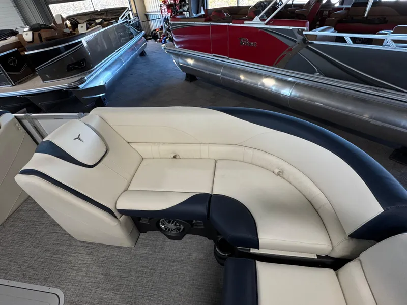 Slide: The Image of 2025 Tahoe Pontoon LTZ Versatile Rear Bench with luxurious seating in showroom. - 14