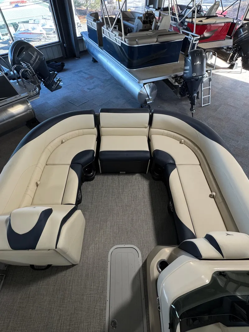 Slide: The Image of 2025 Tahoe Pontoon LTZ Versatile Rear Bench with spacious seating in showroom. - 15