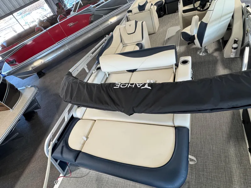 Slide: The Image of 2025 Tahoe Pontoon LTZ Versatile Rear Bench with luxurious seating in showroom. - 3