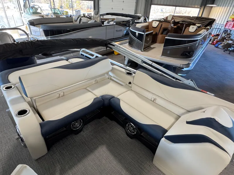 Slide: The Image of 2025 Tahoe Pontoon LTZ Versatile Rear Bench with luxurious seating in showroom. - 7