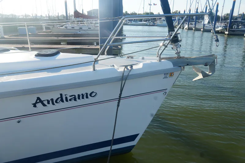 Slide: The Image of Sailboat "Andiamo" docked, Hunter 410 model, 1998, in a marina setting. - 11