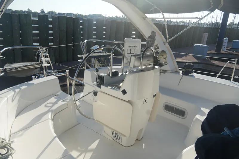 Slide: The Image of Cockpit of a 1998 Hunter 410 sailboat with steering wheel and navigation equipment. - 13