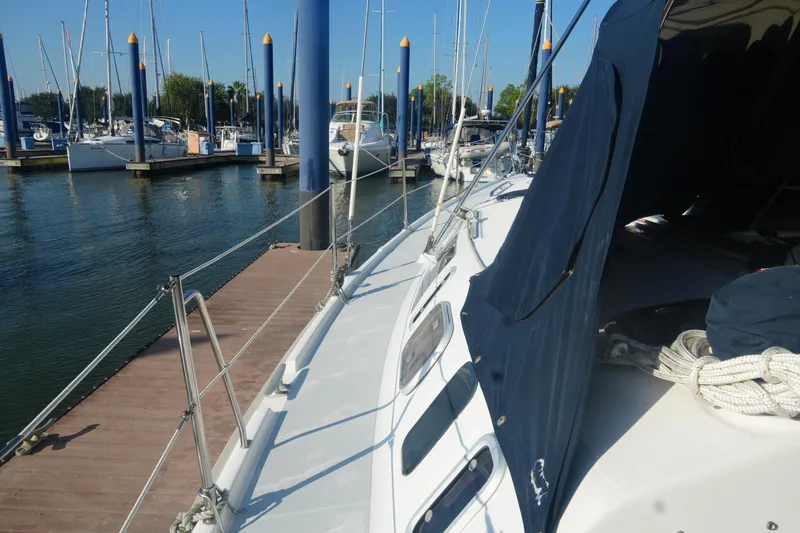 Slide: The Image of Sailboat docked at marina, Hunter 410 model, 1998, with blue canopy and ropes. - 16