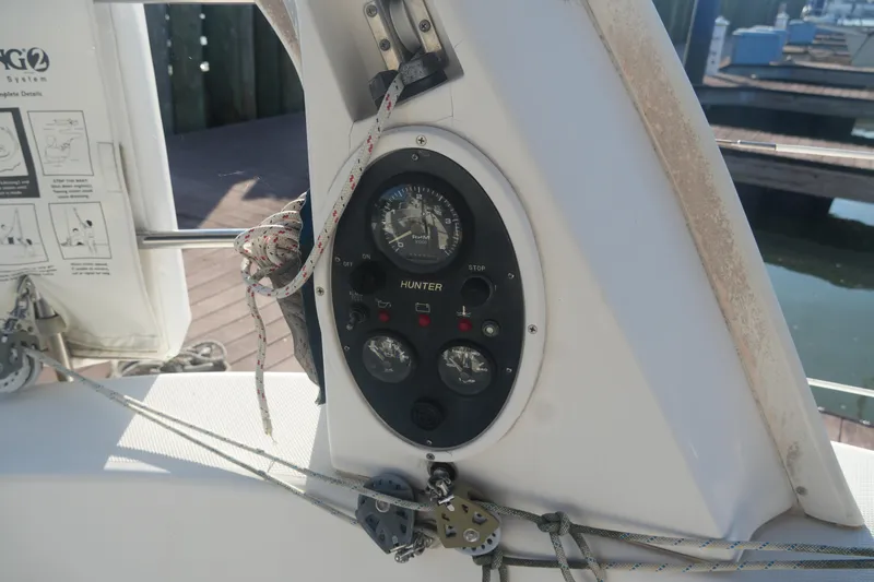 Slide: The Image of Control panel of a 1998 Hunter 410 sailboat with gauges and ropes. - 17