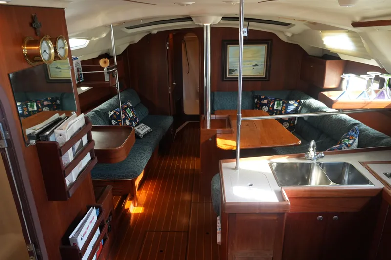 Slide: The Image of Interior of a 1998 Hunter 410 sailboat with cozy seating and wooden finishes. - 19