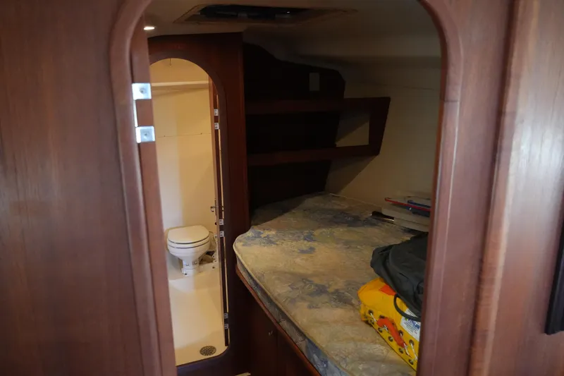 Slide: The Image of 1998 Hunter 410 yacht interior with bed and compact bathroom. - 20