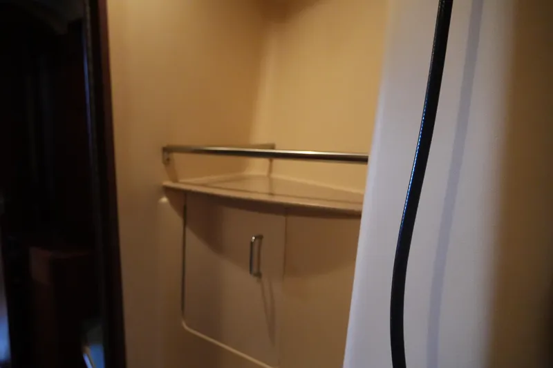 Slide: The Image of Interior of 1998 Hunter 410 sailboat with storage cabinet and railing. - 23