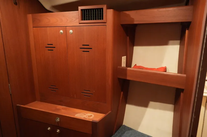 Slide: The Image of Wooden interior of 1998 Hunter 410 sailboat with storage cabinets and shelf. - 25
