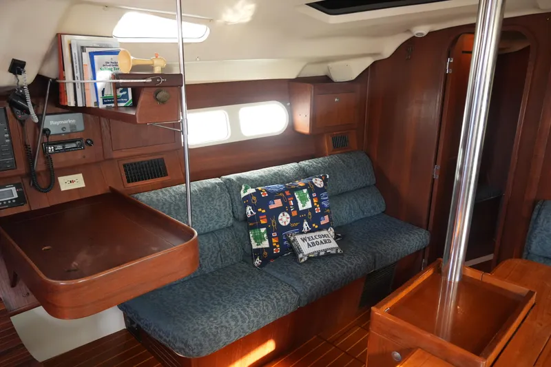 Slide: The Image of Interior of 1998 Hunter 410 sailboat with cozy seating and nautical decor. - 27
