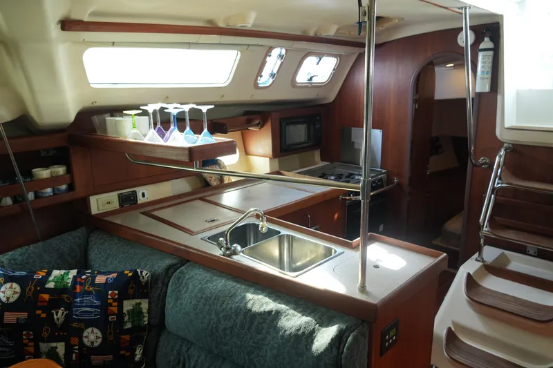 Slide: The Image of Interior of 1998 Hunter 410 sailboat with kitchen and seating area. - 29