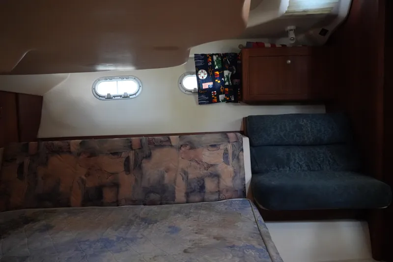 Slide: The Image of Interior cabin of 1998 Hunter 410 sailboat with seating and portholes. - 36