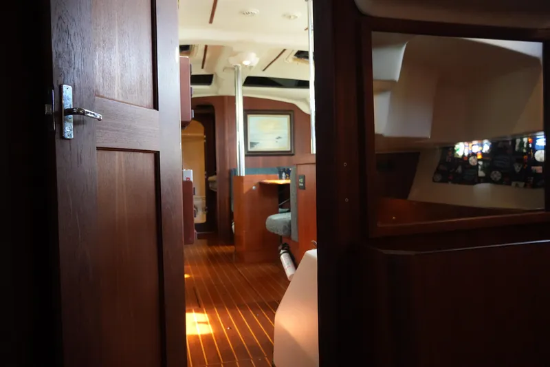 Slide: The Image of Interior view of 1998 Hunter 410 sailboat, featuring wooden finishes and cozy cabin space. - 38