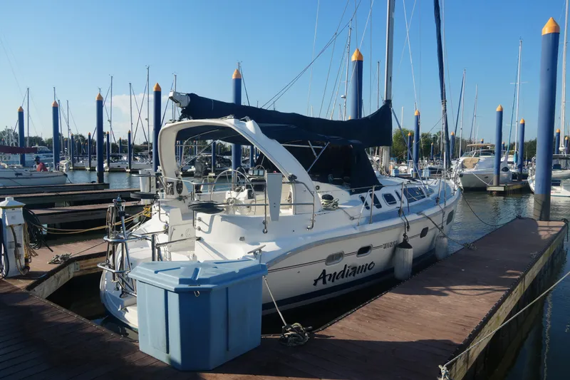 Slide: The Image of 1998 Hunter 410 sailboat docked at marina, sunny day, blue sky, calm water. - 9