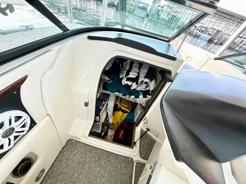 Slide: The Image of Storage compartment inside a 2010 Sea Ray 250 SLX boat, showing organized gear and equipment. - 14