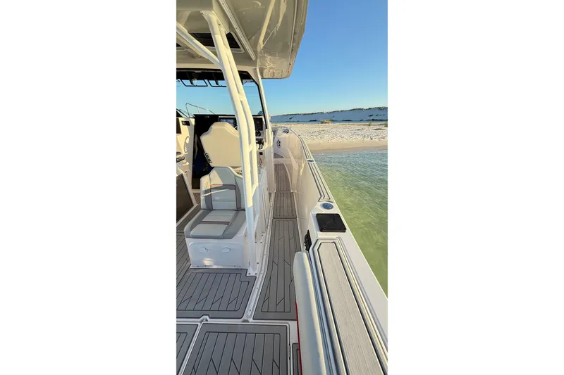 Slide: The Image of 2025 Solara S-310 CW boat docked on sandy beach, showcasing sleek deck design. - 17