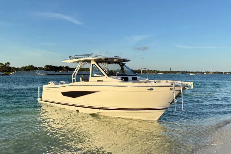 Slide: The Image of 2025 Solara S-310 CW boat on clear water under blue sky. - 2