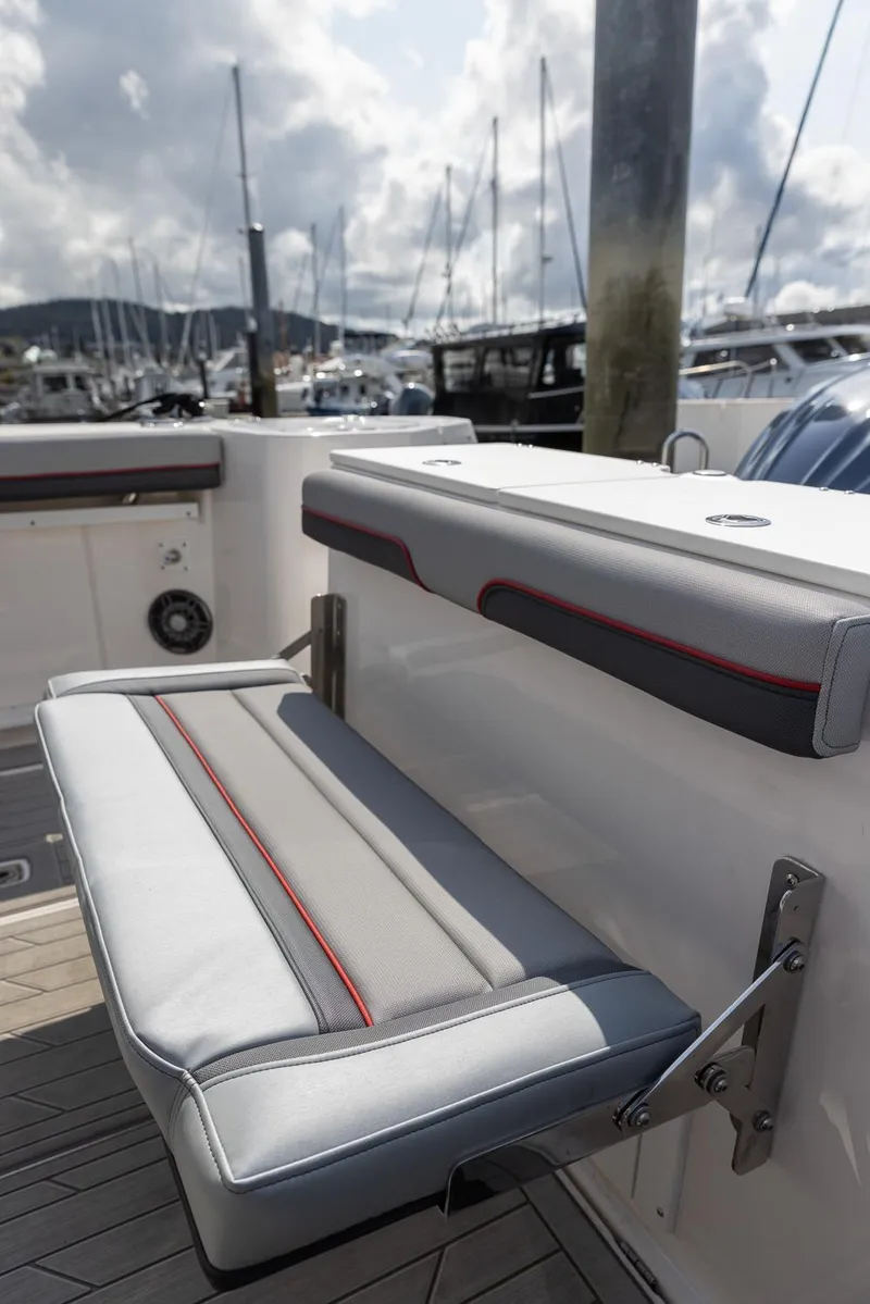 Slide: The Image of 2025 Solara S-310 CW boat seat with marina background and cloudy sky. - 33