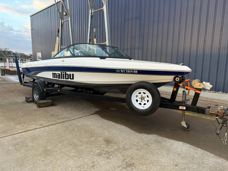 Slide: The Image of 2002 Malibu Response LX boat on trailer, parked outdoors. - 0