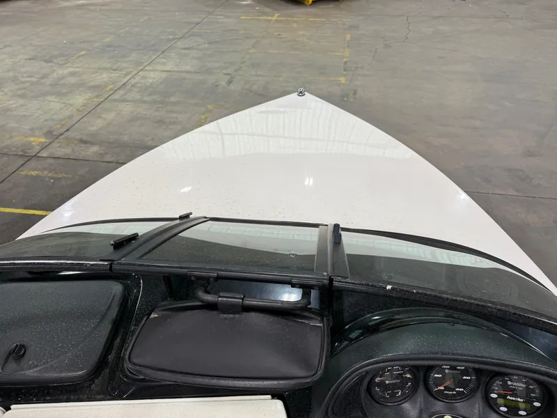 Slide: The Image of 2002 Malibu Response LX boat interior with dashboard and controls in a warehouse setting. - 11