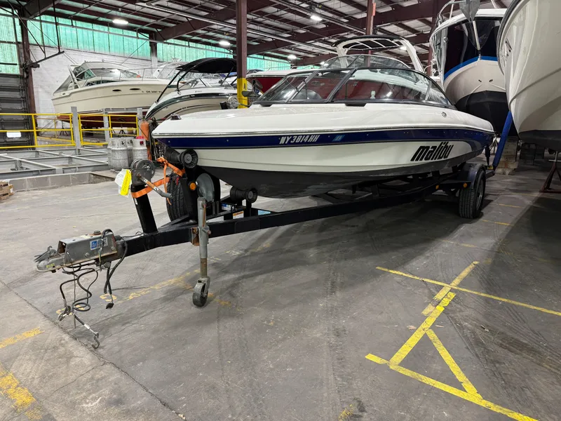 Slide: The Image of 2002 Malibu Response LX boat on trailer in indoor storage facility. - 13