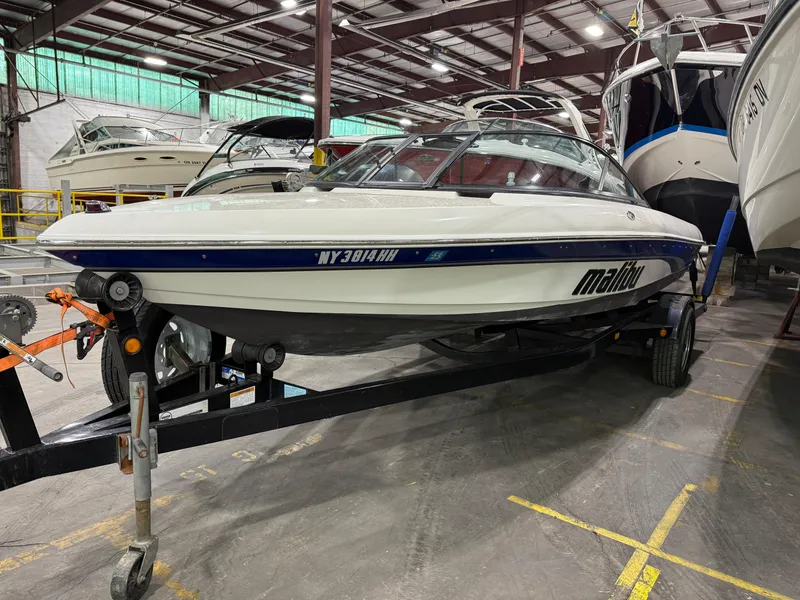 Slide: The Image of 2002 Malibu Response LX boat on trailer in indoor storage facility. - 14