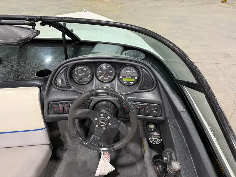 Slide: The Image of 2002 Malibu Response LX boat dashboard with steering wheel and instrument panel. - 6