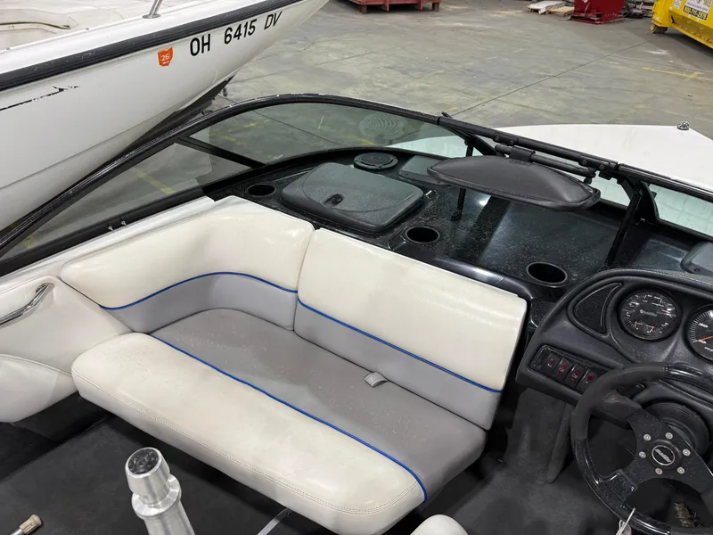 Slide: The Image of 2002 Malibu Response LX boat interior with white seating and dashboard controls. - 7