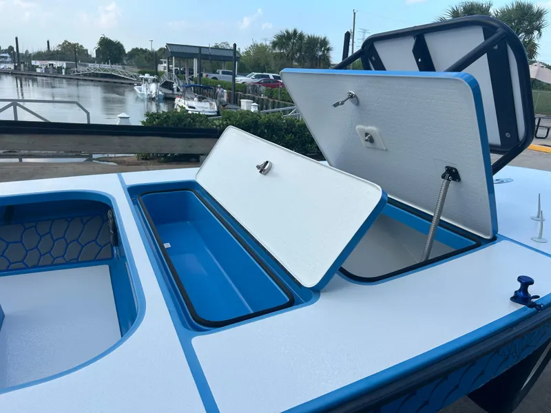 Slide: The Image of 2019 East Cape Fury boat with open storage compartments at a marina. - 15