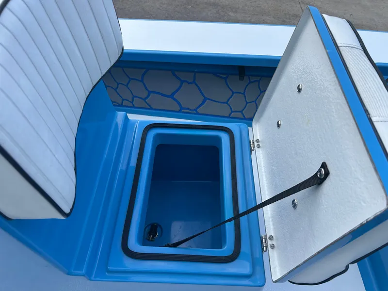 Slide: The Image of 2019 East Cape Fury boat storage compartment with open lid and cushioned seating. - 17