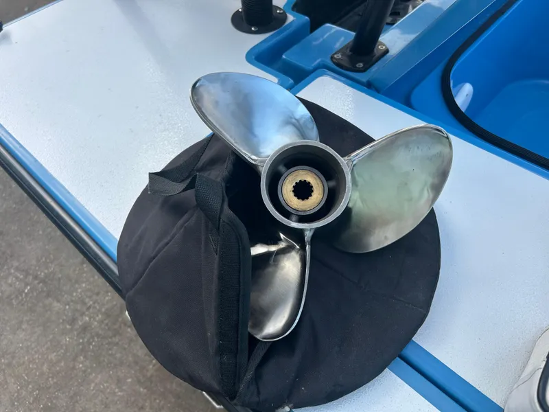 Slide: The Image of 2019 East Cape Fury boat propeller on a black cover, displayed on a blue surface. - 19