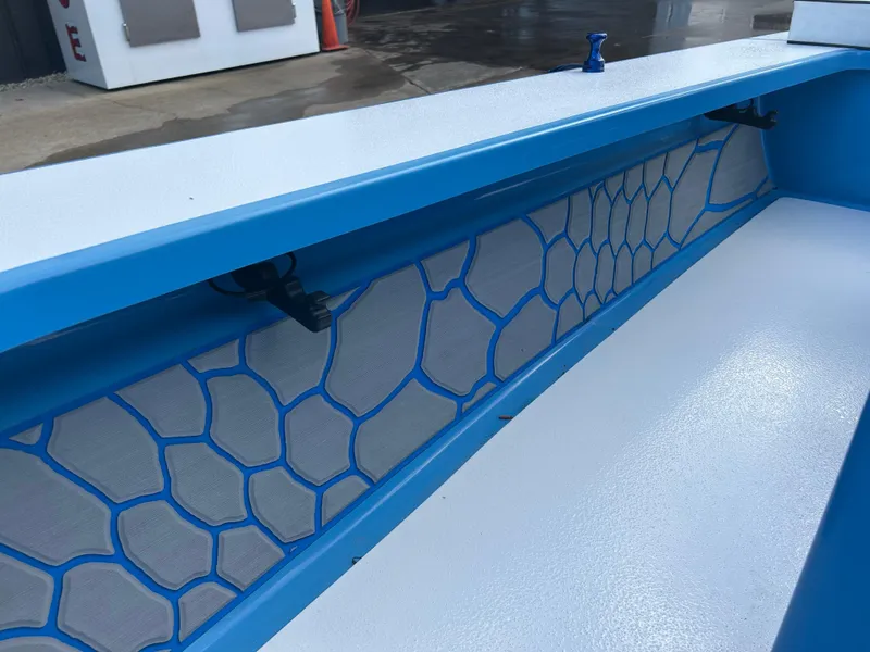 Slide: The Image of 2019 East Cape Fury boat interior with blue hexagonal pattern design. - 23