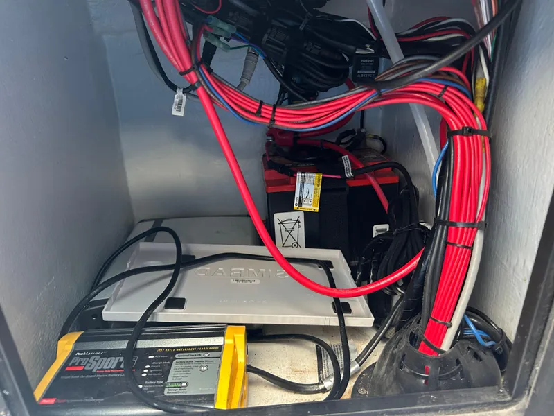 Slide: The Image of 2019 East Cape Fury electrical compartment with wiring, battery, and charger setup. - 25