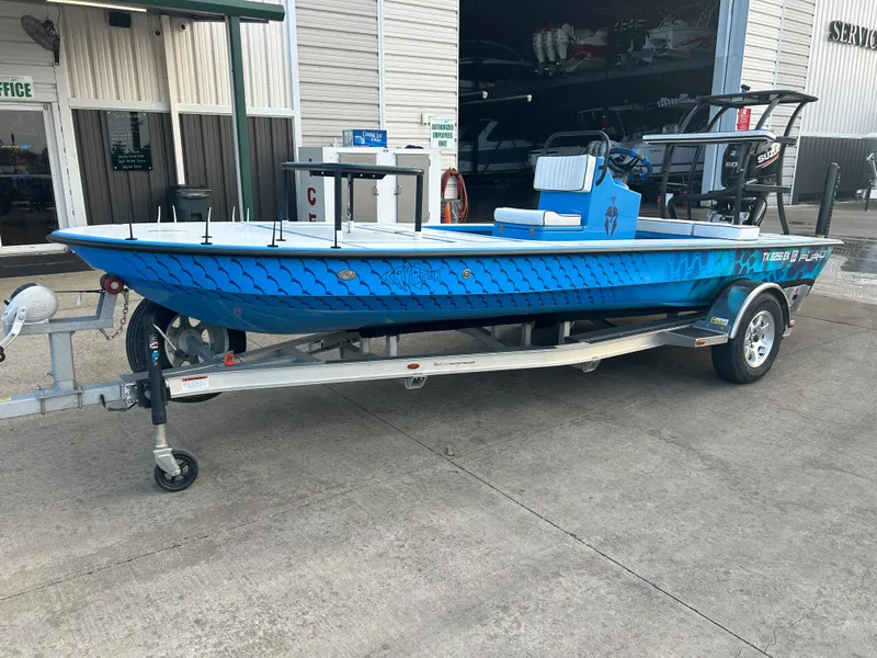 Slide: The Image of 2019 East Cape Fury boat in blue on a trailer, parked outside a building. - 3