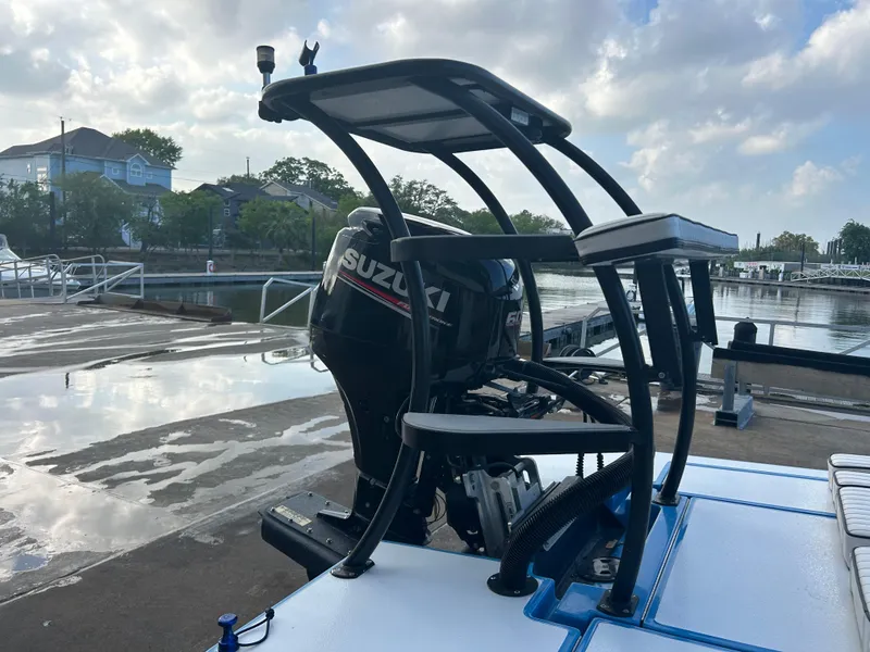 Slide: The Image of 2019 East Cape Fury boat with Suzuki engine at dockside under cloudy sky. - 6