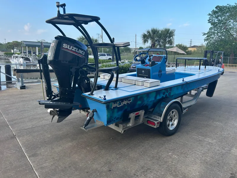 Slide: The Image of 2019 East Cape Fury boat with Suzuki motor on trailer, parked near marina. - 8