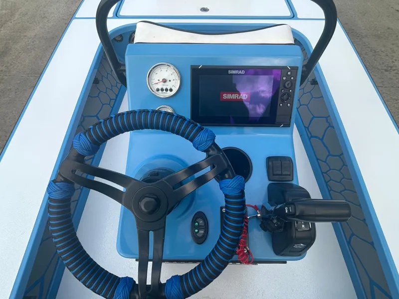 Slide: The Image of 2019 East Cape Fury boat console with steering wheel and Simrad display. - 9