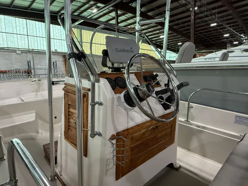 Slide: The Image of 1974 Boston Whaler 17 Montauk boat interior with Garmin navigation system. - 15