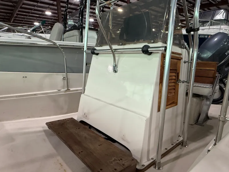 Slide: The Image of 1974 Boston Whaler 17 Montauk boat interior with wooden accents and metal railings. - 16