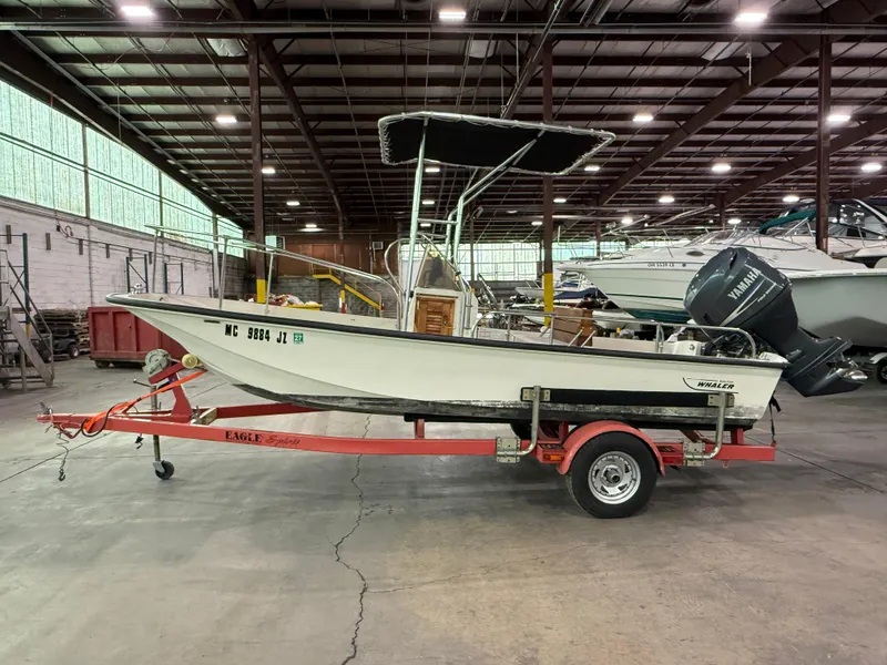 Slide: The Image of 1974 Boston Whaler 17 Montauk boat on trailer in indoor storage facility. - 2