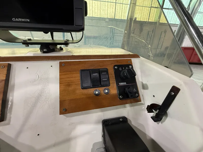 Slide: The Image of 1974 Boston Whaler 17 Montauk dashboard with Yamaha controls and Garmin display. - 6