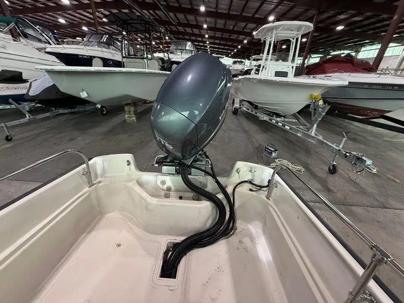 Slide: The Image of 1974 Boston Whaler 17 Montauk boat in storage, showcasing motor and interior details. - 8